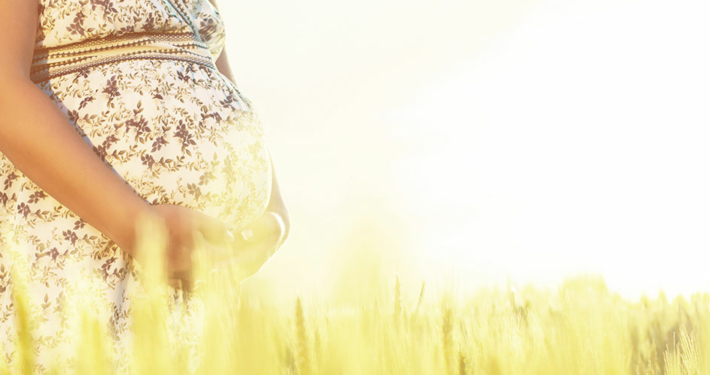 stock-photo-pregnant-woman-relaxing-in-nature-on-a-beautiful-sunny-day-a-crop-of-a-pregnant-woman-s-stomach-366669791